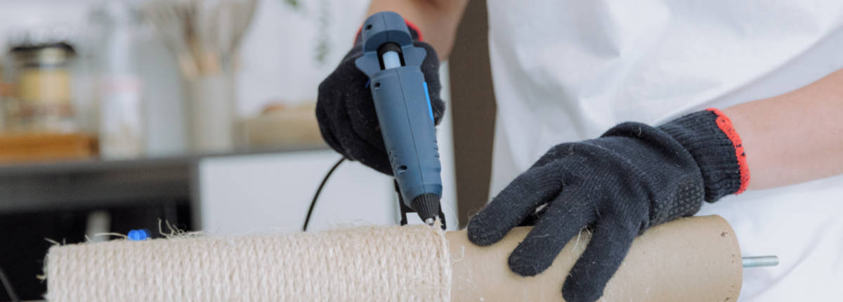 A man is renovating a cat's house at home.